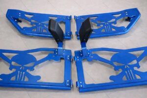 Aftermarket tubular half doors designed for a Jeep Wrangler, featuring a distinctive "Punisher" skull design cutout.